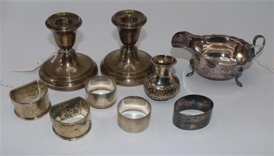 Pair of silver dwarf candlesticks (weighted), cream jug, small embossed vase and 5 napkin rings (9)(-)